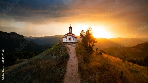 Small chapel on top of a hill during sunset