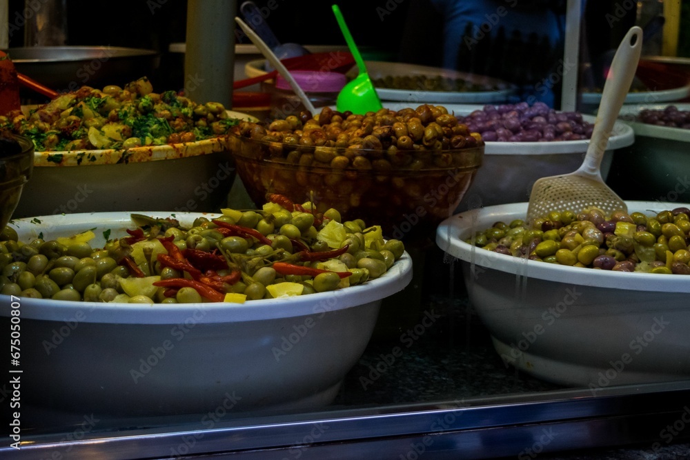 Market stall selling pickled olives preserved in olive oil, in Fes el Bali, in city of Fez, Morocco Market stall selling pickled olives preserved in olive oil, in Fes el Bali, in city of Fez, Morocco