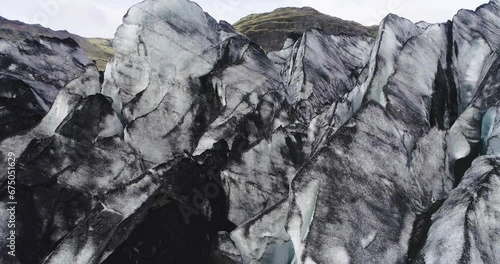 Drone footage over Myrdalsjokull glacier and green hills in Iceland photo