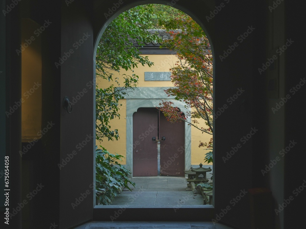 Fototapeta premium Open door at the end of a dark, narrow hallway