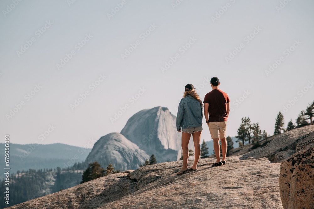 Scenic view of a couple standing on a rock in Yosemite National park
