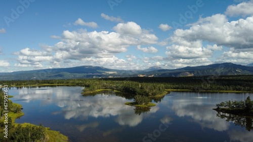 Aerial view of Denali National Park in Alaska with the mountains towering over a serene lake