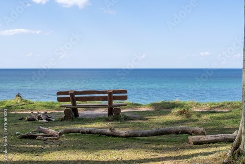 Empty bench in front of a tranquil sea