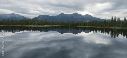 Panoramic view of green trees and mountains reflecting on a tranquil lake on a cloudy day