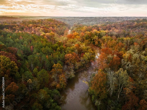 Aerial view of an idyllic autumnal scene with a tranquil a river