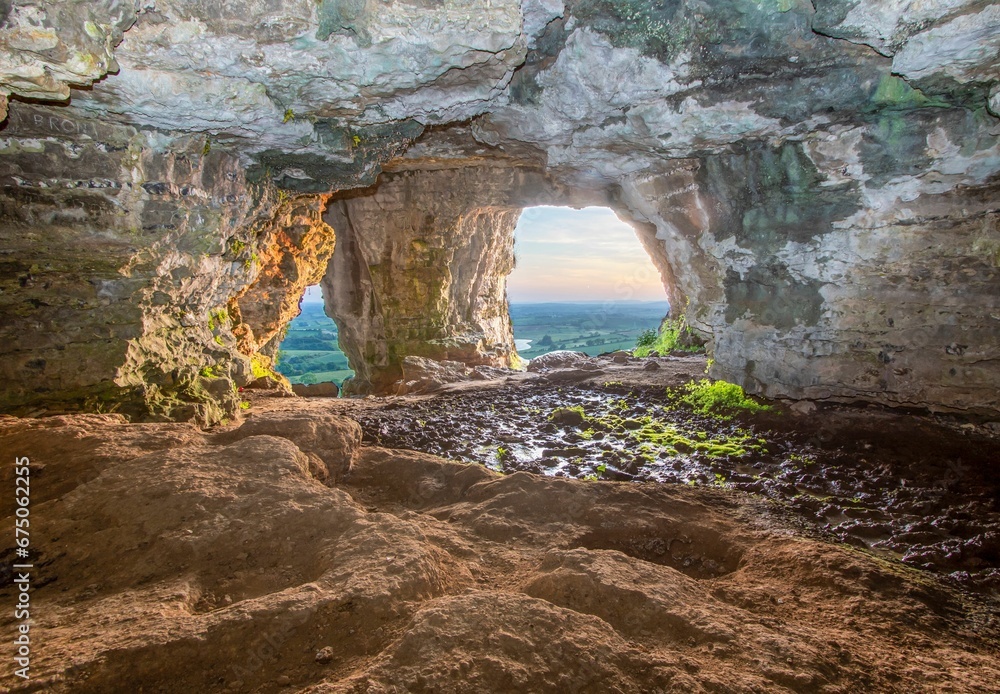 Scenic view of sunset over a landscape seen from a cave
