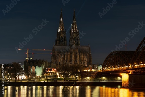 Obraz na płótnie A breathtaking view of Cologne Cathedral and the Rhine River illuminated by the