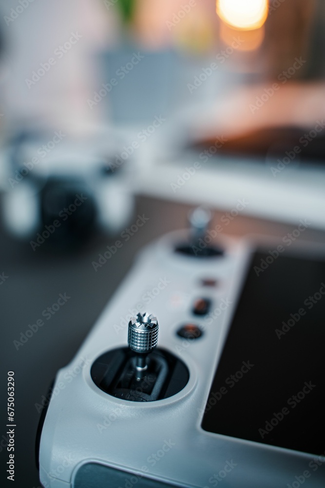 Vertical closeup of a game system on a desk with remotes