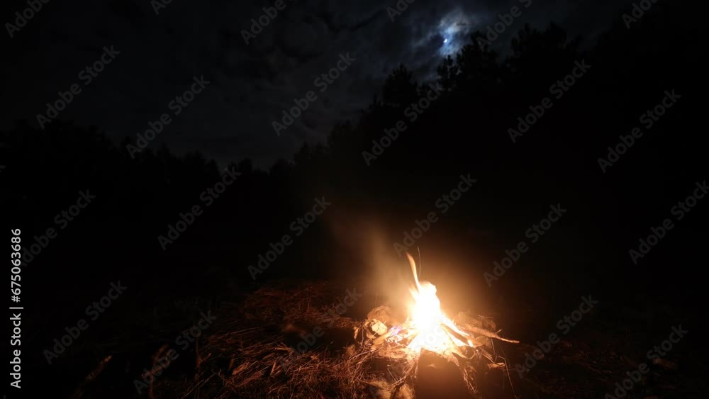 Time lapse view of campfire under night clouds in the sky at night Time lapse view of campfire under night clouds in the sky at night