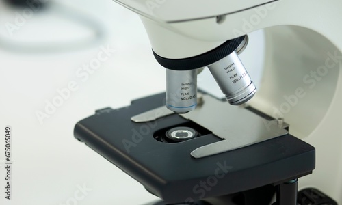 Closeup of a white microscope in a laboratory setting