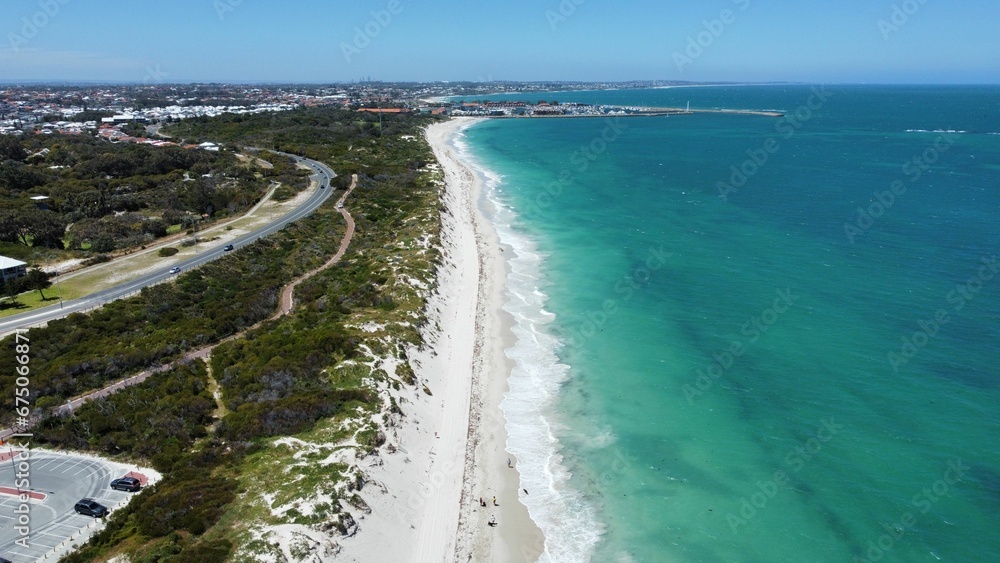 Aerial view of sandy beach with soft ocean waves