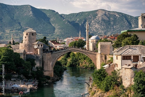 the village and bridge in mostar, bosnia has one bridge spanning a mountain range photo