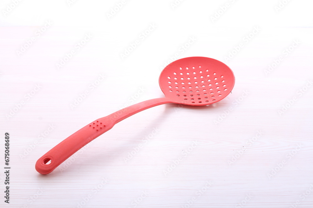 red cooking utensils on a bright background red cooking utensils on a bright background