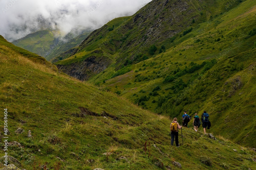 some people are hiking in the mountains, and some of them are carrying backpacks some people are hiking in the mountains, and some of them are carrying backpacks