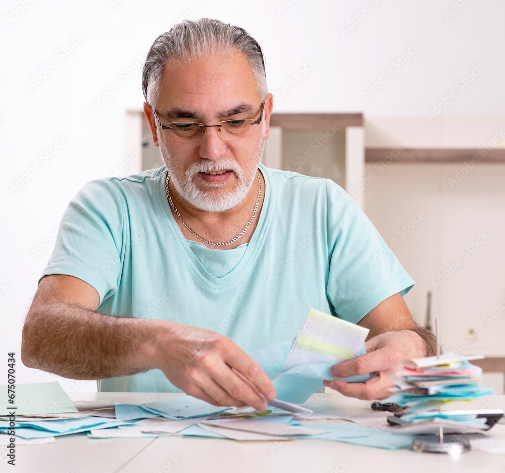 White bearded old man in budget planning concept White bearded old man in budget planning concept
