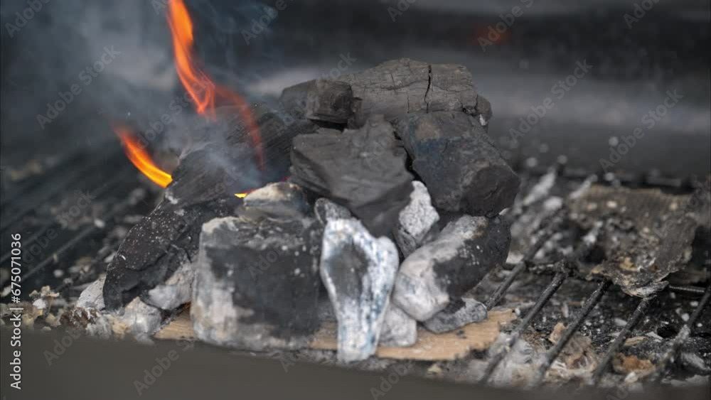 Slow motion of burning charcoal with a flame and smoke coming out. Starting a fire grill concept. Slow motion of burning charcoal with a flame and smoke coming out. Starting a fire grill concept.
