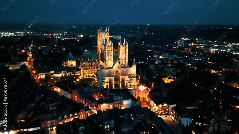 Aerial drone video captures the renowned Lincoln Cathedral in Lincolnshire, UK, at dusk, showcasing its majestic Gothic architecture with illumination. Aerial drone video captures the renowned Lincoln Cathedral in Lincolnshire, UK, at dusk, showcasing its majestic Gothic architecture with illumination.