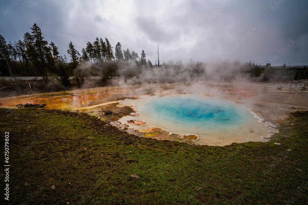 Picturesque view of a vibrant hot spring in Yellowstone National Park.