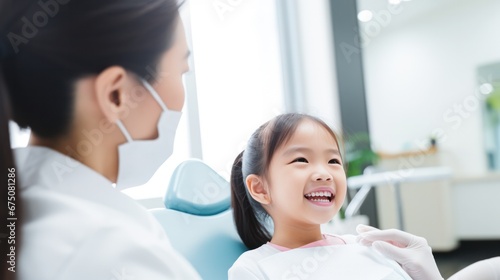 happiness cute girl and dentist for checkup and treatment of teeth at clinic, Smiling girl on bed at dentist clinic photo