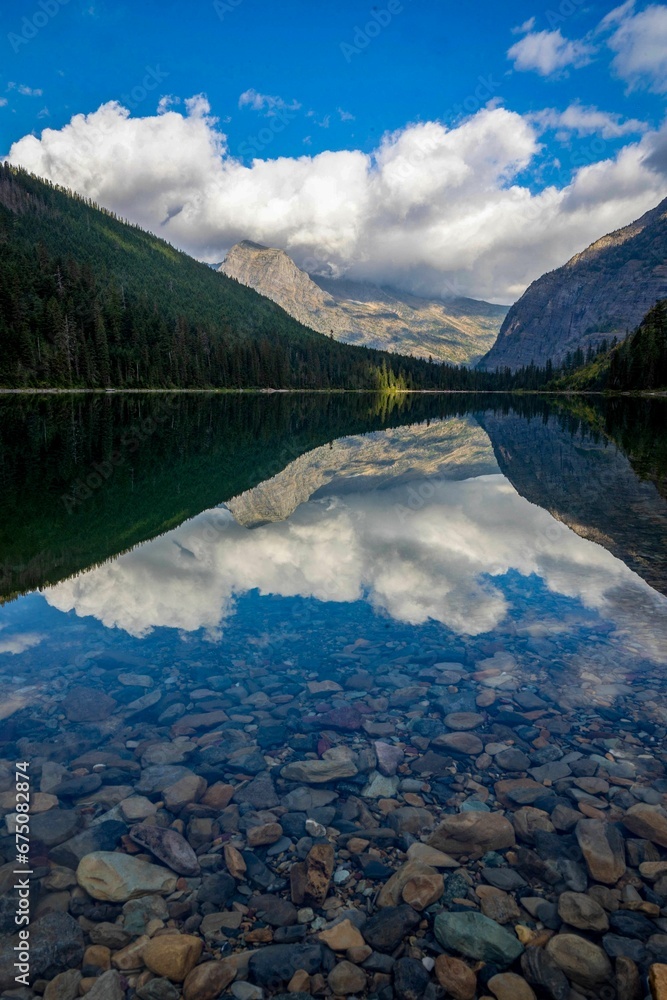 Avalanche Lake at Glacier National Park, Montana surrounded by lush green trees and mountain peaks