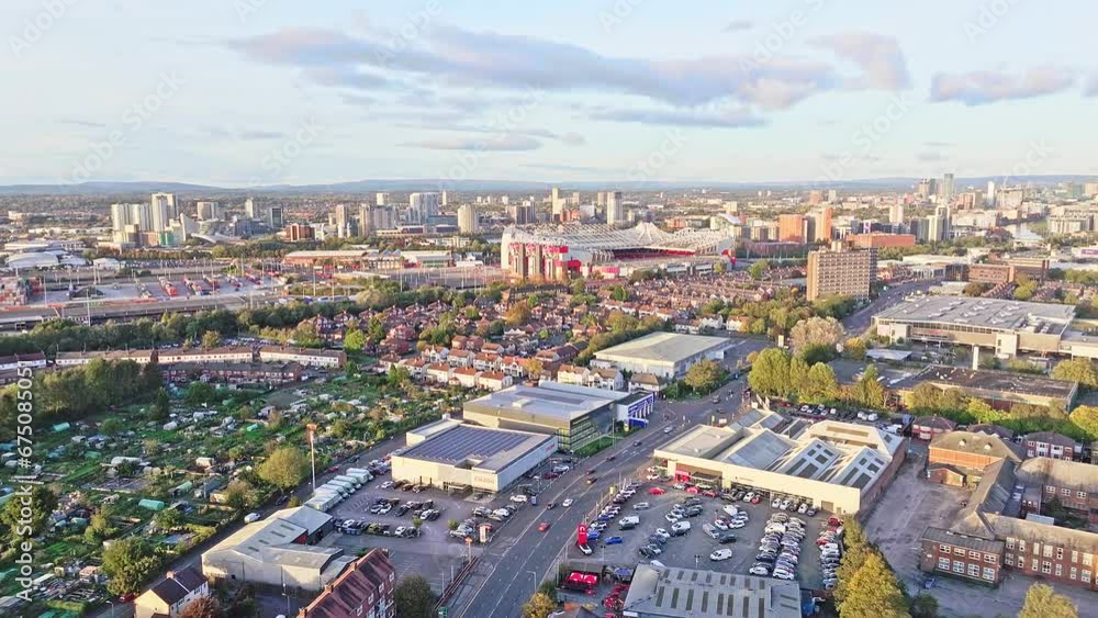 Aerial dolly shot flying away from the Old Trafford stadium in Manchester in landscape format with infrastructure all around. Aerial dolly shot flying away from the Old Trafford stadium in Manchester in landscape format with infrastructure all around.