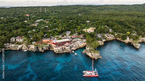 Negril, Jamaica, aerial landscape view of area around the famous Rick's Cafe in Negril, with boats near the cliff jumping spot and many people at the cliff photo