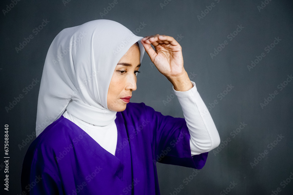 Asian hijab woman wearing headscarf and purple dress Asian hijab woman wearing headscarf and purple dress