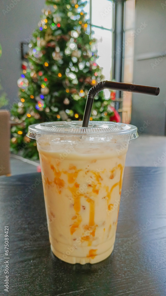 Fresh caramel milk on a Christmas tree theme background Fresh caramel milk on a Christmas tree theme background
