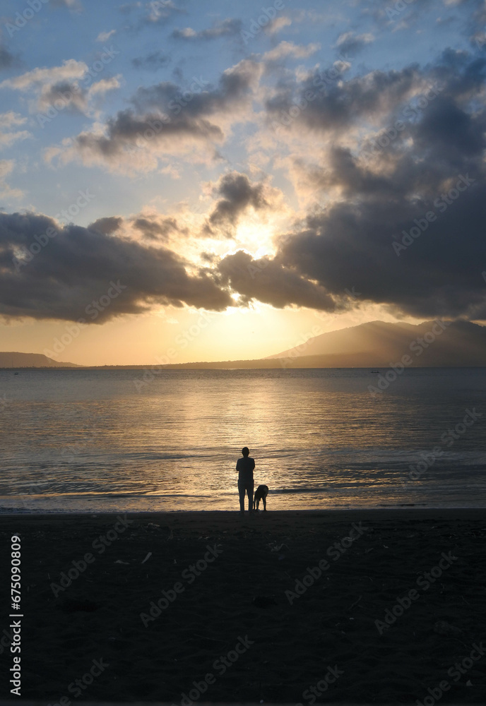Human silhouette on a beach at sunrise. Human silhouette on a beach at sunrise.