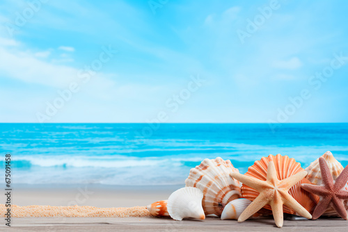 Coastal concept with seashells and starfish arranged on a blue wooden background, capturing the essence of a beach scene. 