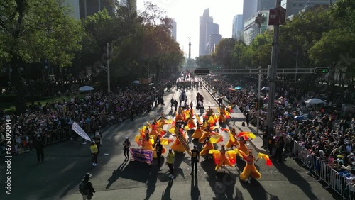 Aerial view of Mexico city paseo de la reforma avenue celebratin a dia de muertos parade on a sunny day, cdmx day of the death parade