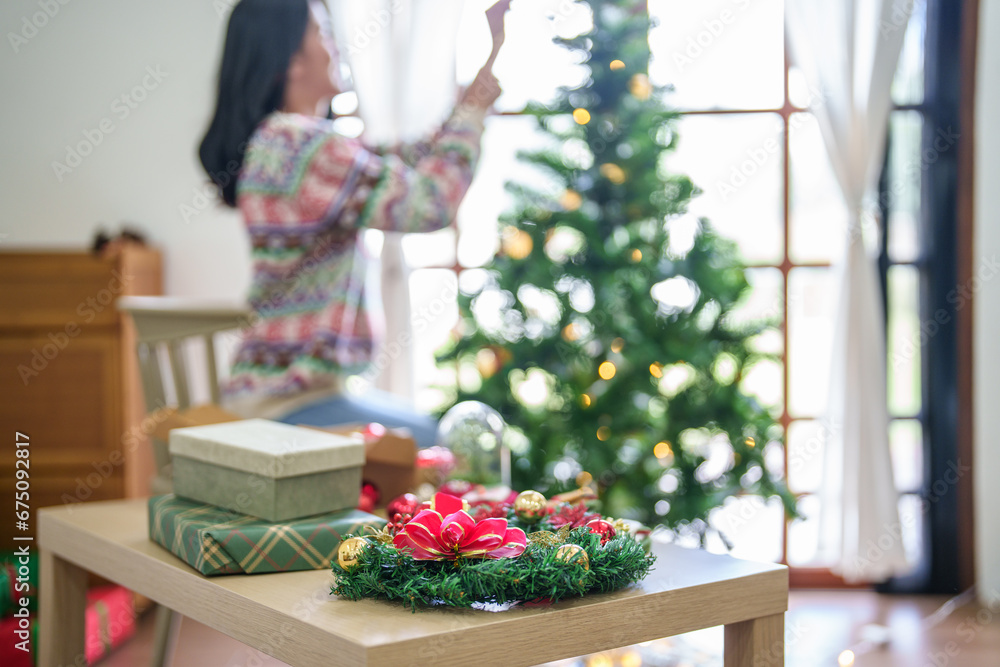 Happy asian woman Decorating Christmas tree for xmas holiday Happy asian woman Decorating Christmas tree for xmas holiday