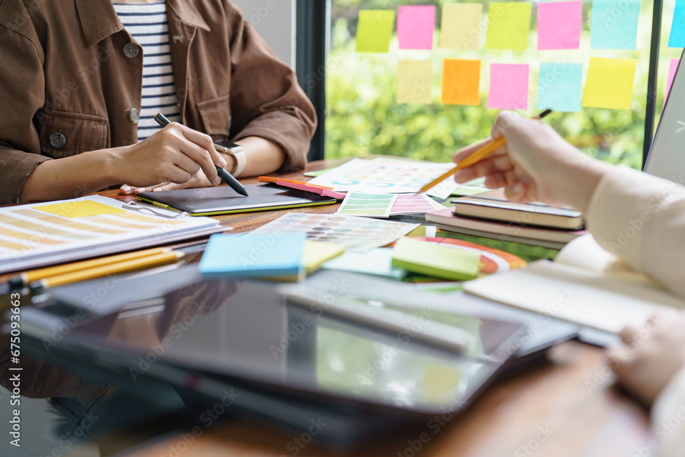 Teamwork brainstorming Creative idea Business project. Business People meeting taking notes while discussing with Color swatch samples to share idea Teamwork brainstorming Creative idea Business project. Business People meeting taking notes while discussing with Color swatch samples to share idea