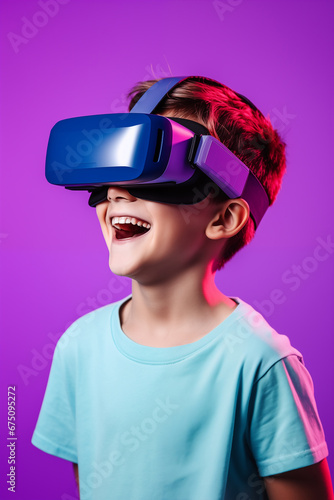 Young boy getting experience using VR headset glasses isolated on a purple background © dewaai