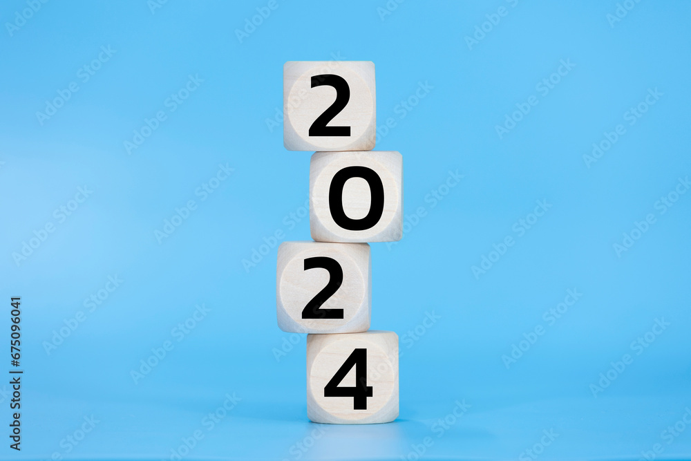 Wooden dice 2024 happy new year on blue background pastel black number Wooden dice 2024 happy new year on blue background pastel black number
