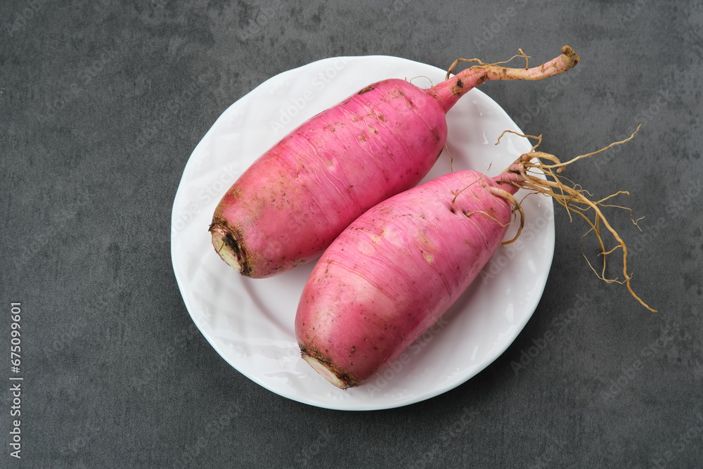 Fresh Red Radish (Lobak Merah) on wooden background.
