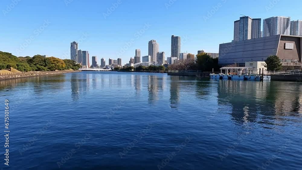 Calm blue waters in Takeshiba Tideland of Tokyo. View on highrise skyscrapers, modern waterfron. Japan Calm blue waters in Takeshiba Tideland of Tokyo. View on highrise skyscrapers, modern waterfron. Japan