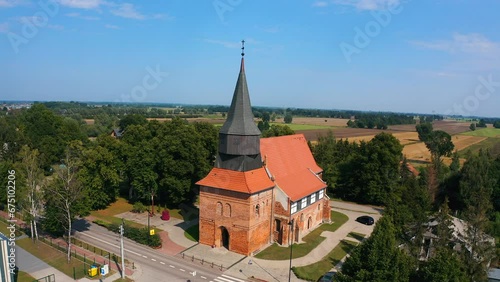 Aerial shot, top view of beautiful medieval church in Cedry Wielkie, Poland photo