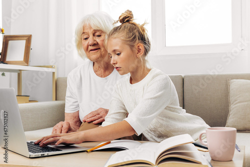 Laptop granddaughter family bonding selfie child hugging sofa grandmother smiling togetherness © SHOTPRIME STUDIO