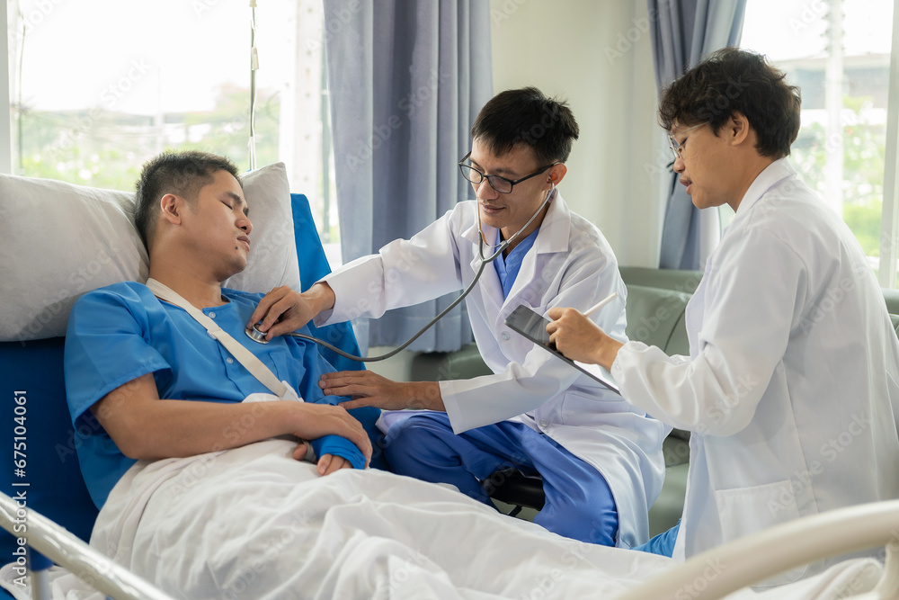 Male patient in a hospital bed with medical staff at the bedside giving encouragement and advice on treatment. Male patient in a hospital bed with medical staff at the bedside giving encouragement and advice on treatment.