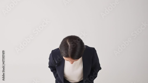 お辞儀して謝罪するビジネスウーマン　白背景