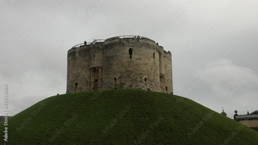 Hand-held shot of tourists looking over the walls at Cliffords Tower, York Hand-held shot of tourists looking over the walls at Cliffords Tower, York
