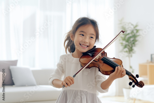 little girl having fun standing playing violin on blured white livingroom background