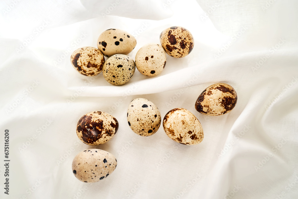 Quail eggs on a white linen towel close-up. Quail eggs on a white linen towel close-up.