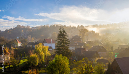 Misty autumn morning over a mountain village. Fog over the houses in a rural area