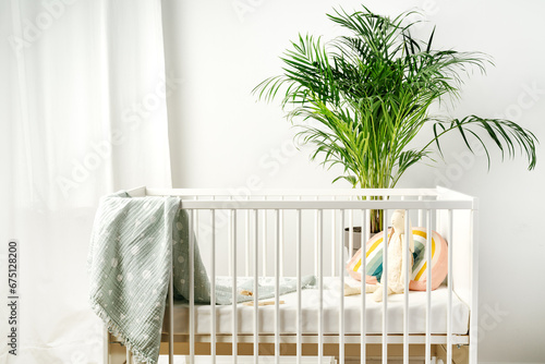 Fototapeta Naklejka Na Ścianę i Meble -  White wooden baby crib in nursery room