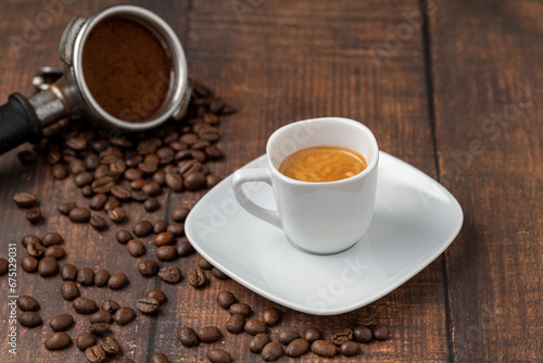 Fresh espresso coffee together decorated with coffee beans on wooden table