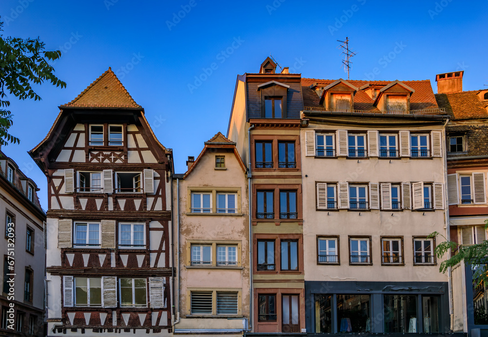 Ornate traditional half timbered houses with steep roofs in the old town of Grande Ile, the historic center of Strasbourg, Alsace, France at sunset