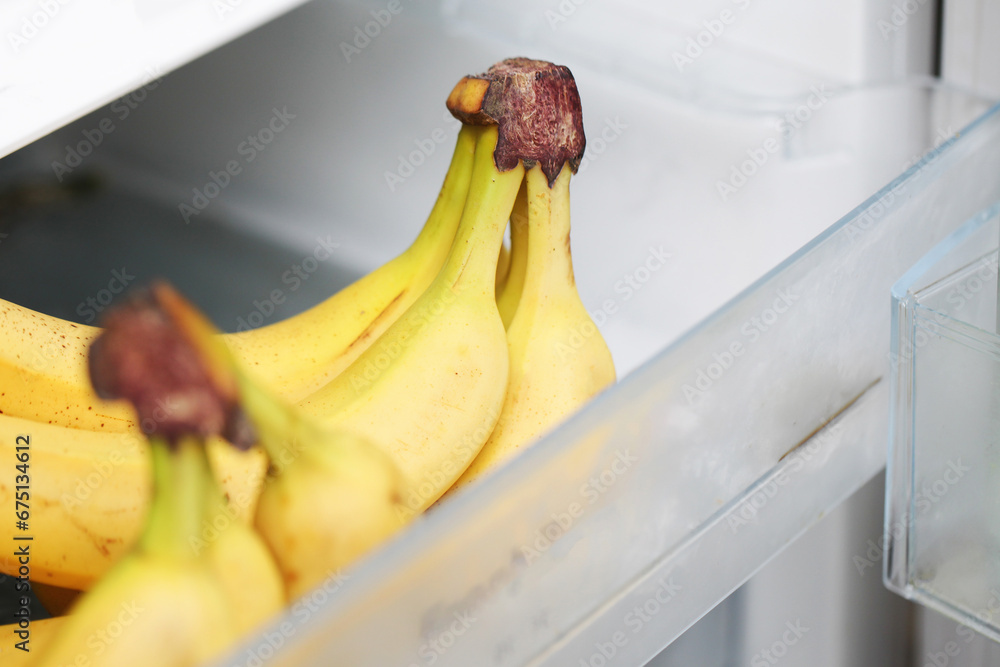 Bananas in fridge. Isolated on white fridge door. Yellow fruit with