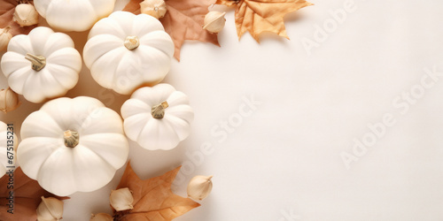 Autumn cozy composition with white pumpkins, autumn leaves on white background.